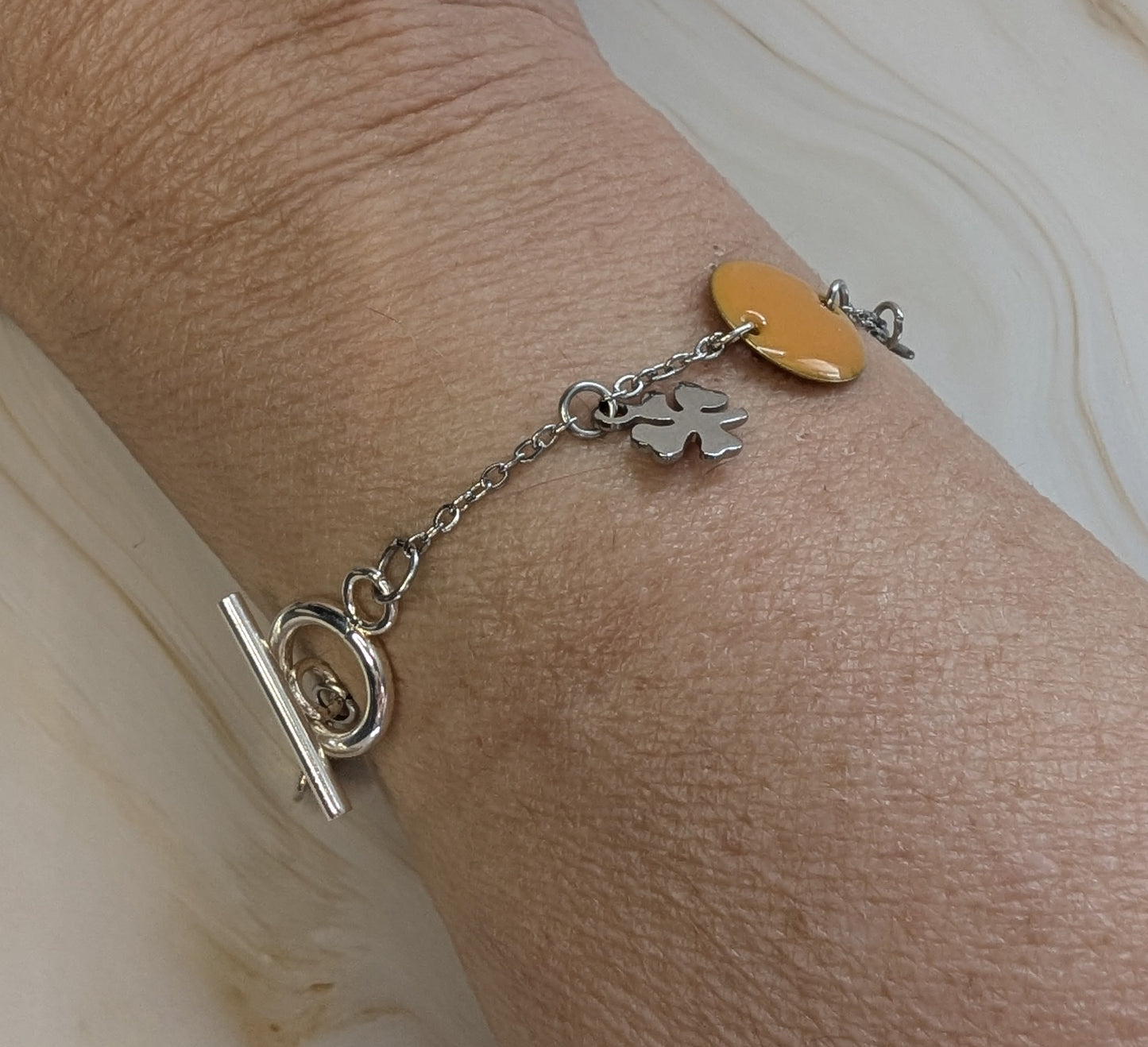 Bracelet Floréale porté au poignet, apportant une touche élégante et printanière à une tenue décontractée.