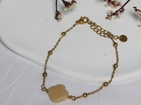 Bracelet doré Cléa en acier inoxydable avec perle de tagua naturelle blanc cassé – bijou fin et élégant.