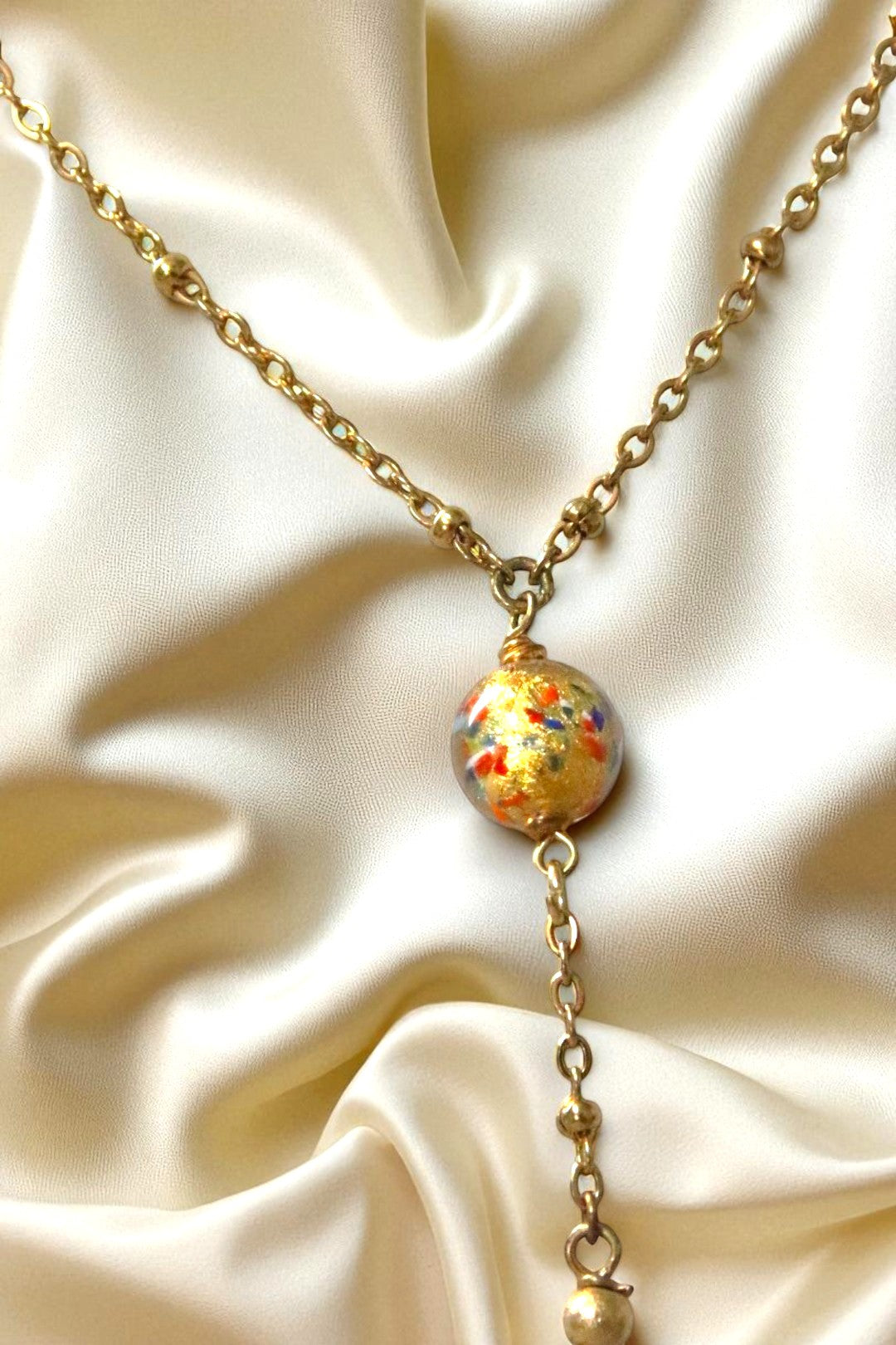 Collier Arlequin avec perle de Murano multicolore et chaîne en acier inoxydable.