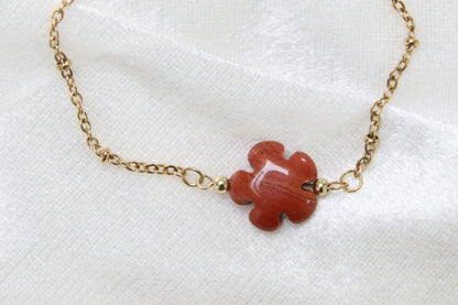 Gros plan sur bracelet en Jaspe rouge en forme de fleur.